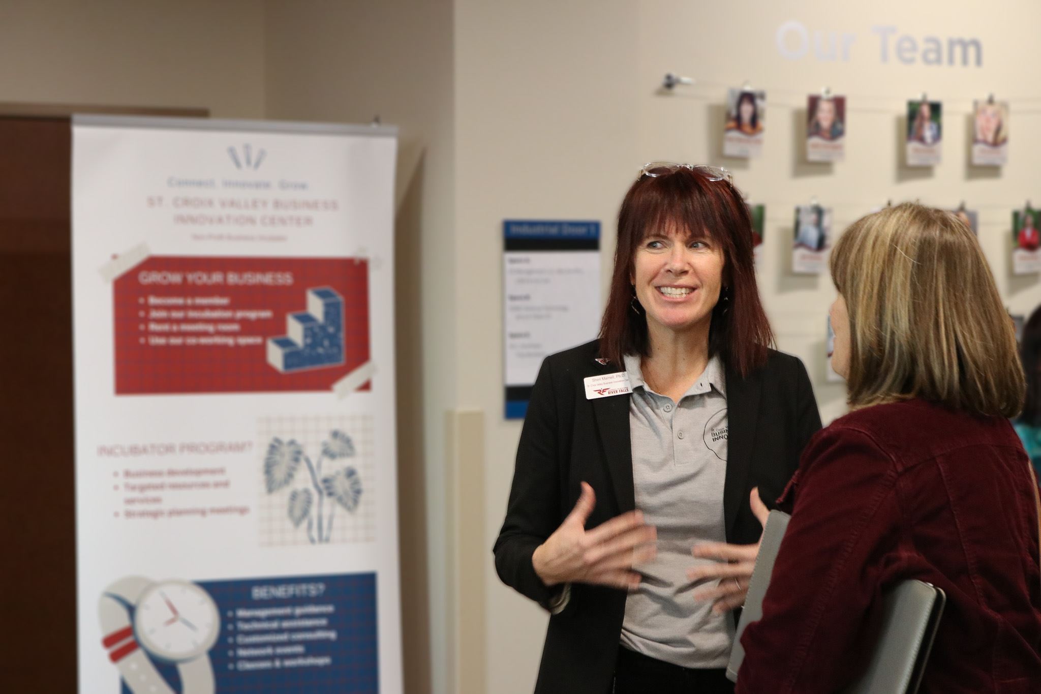 Sheri Marnell speaking with guest at Innovation Center graduation